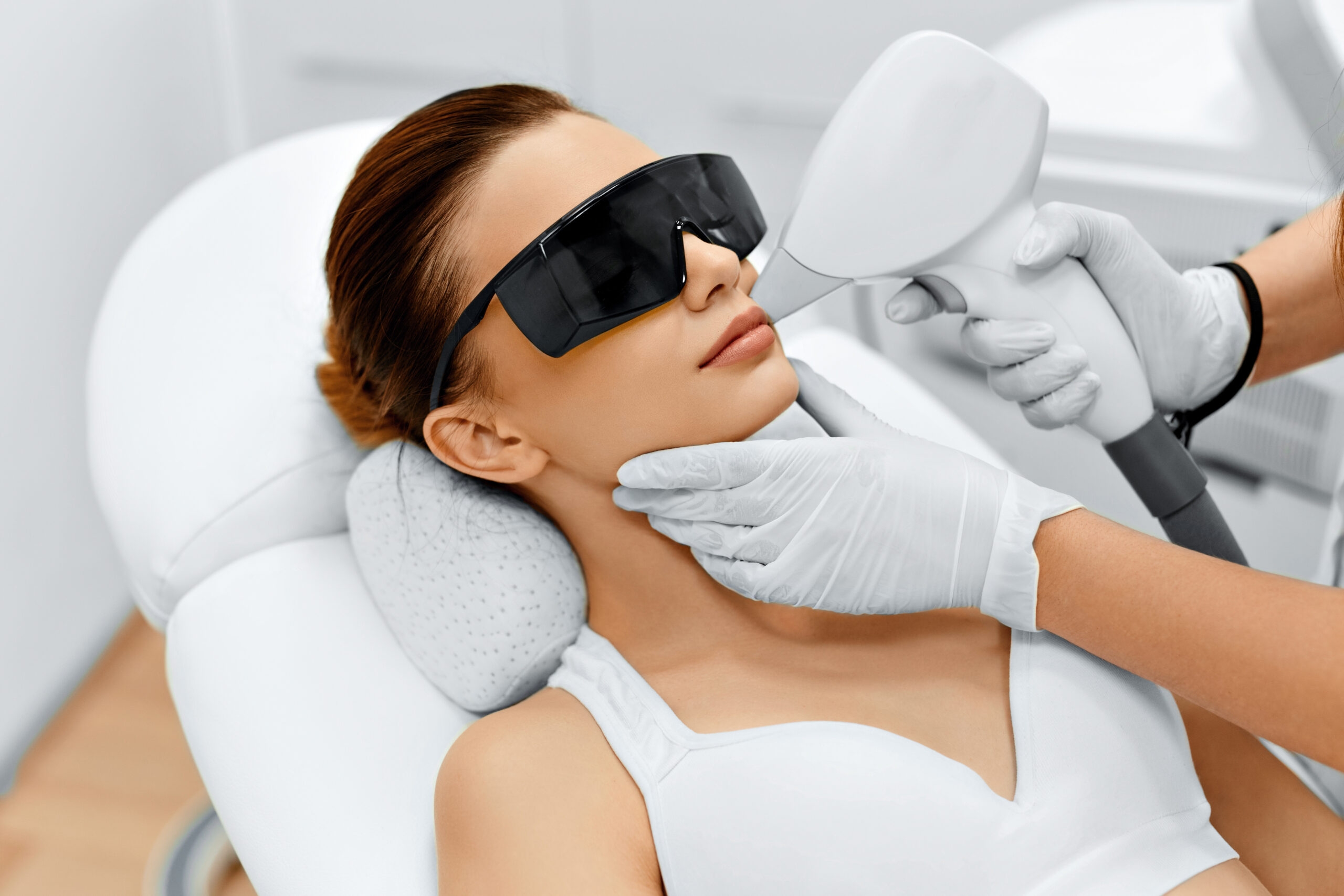 Face Care. Facial Laser Hair Removal. Beautician Giving Laser Epilation Treatment To Young Woman's Face At Beauty Clinic. Body Care. Hairless Smooth And Soft Skin. Health And Beauty Concept.